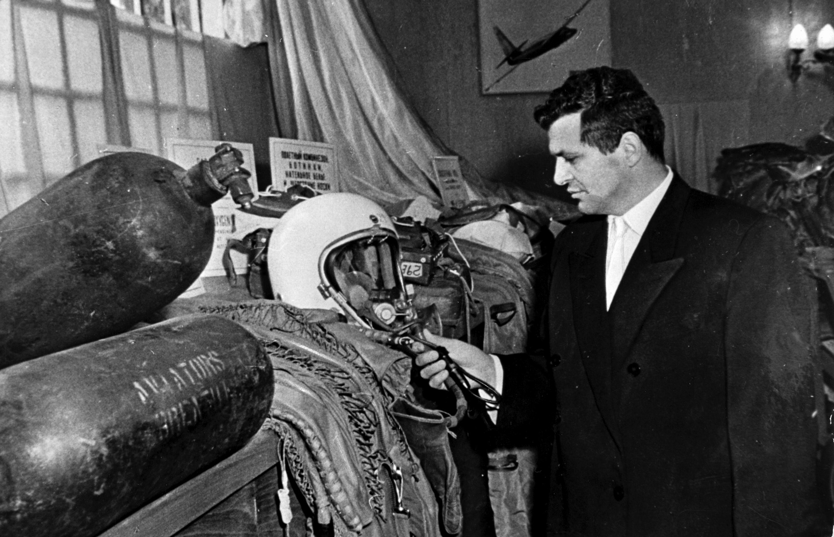 Francis Gary Powers looks at his flight helmet at a Moscow exhibition related to his trial.