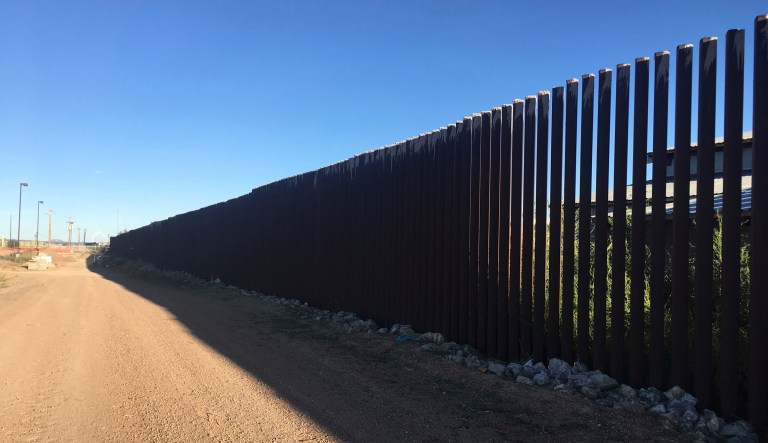 In this Oct. 3, 2018 photo, a border fence in Columbus, N.M., sits along the U.S.-Mexico border at sunset. The  small New Mexico village once attacked by Mexican revolutionary Pancho Villa is rejecting talk of a wall and troops while embracing its legacy along the U.S.-Mexico border. U.S. Defense Secretary Jim Mattis last week cited Villa's 1916 raid of Columbus, New Mexico, as an example for why President Trump was deploying active-duty troops to the U.S.-Mexico border.