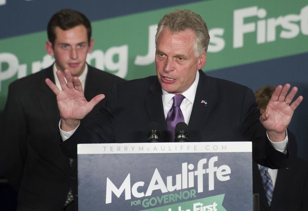 With his son Jack, 20, looking on, Democratic Virginia Gov.-elect Terry McAuliffe addresses supporters during his election victory party in Tysons Corner, Va., Tuesday. (AP Photo/Cliff Owen)