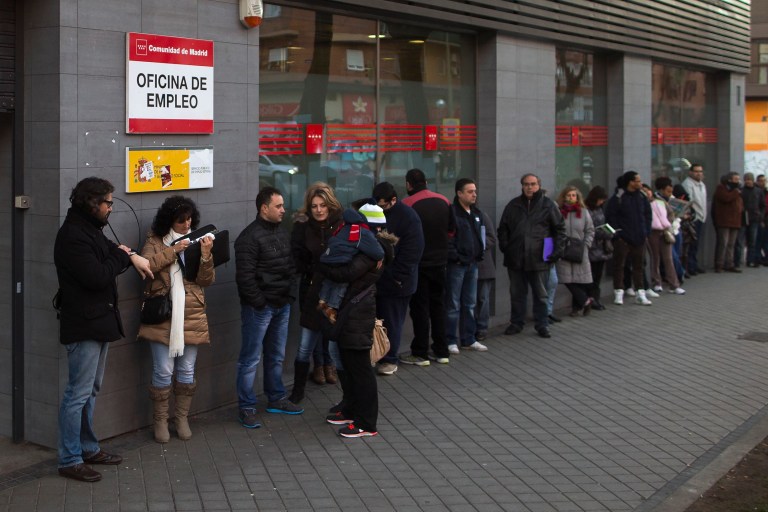 People wait outside to enter an unemployment registry office in Madrid, Spain, Thursday, Jan. 23, 2014.  Spainâs national statistics agency says the unemployment rate for the fourth quarter of 2013 edged up slightly, leaving it stuck at the sky-high level of 26 percent.
The agency says joblessness for the October-December period rose to 26.03 percent from 25.98 percent in the previous quarter and that the number of unemployed stood at a rounded 5.9 million people.
The unemployment report released Thursday said jobs were lost in Spainâs services, construction and industry sectors but were added in agriculture.
Government officials say Spainâs sluggish economy is stabilized and on track for job growth but economists predict it will take years to bring the jobless rate down to a more tolerable level.  Banner reads 