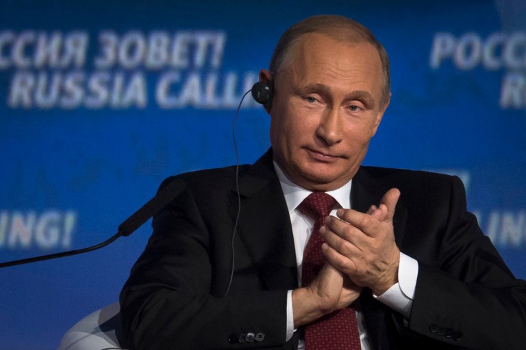 Russian President Vladimir Putin applauds during an investment conference Russia Calling in Moscow on Thursday, Oct. 2, 2014.  (AP Photo/Ivan Sekretarev)