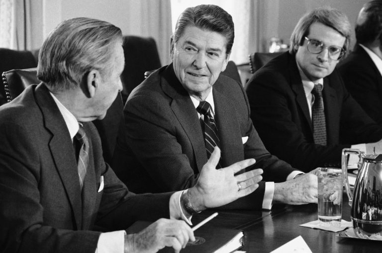 President Ronald Reagan talks with Treasury Secretary Donald Regan, left, while office of Management and Budget Director David Stockman looks on in the Cabinet Room of the White House, Monday, Jan. 28, 1985 in Washington at a meeting on the deficit with business leaders from around the nation. (AP Photo/Dennis Cook)