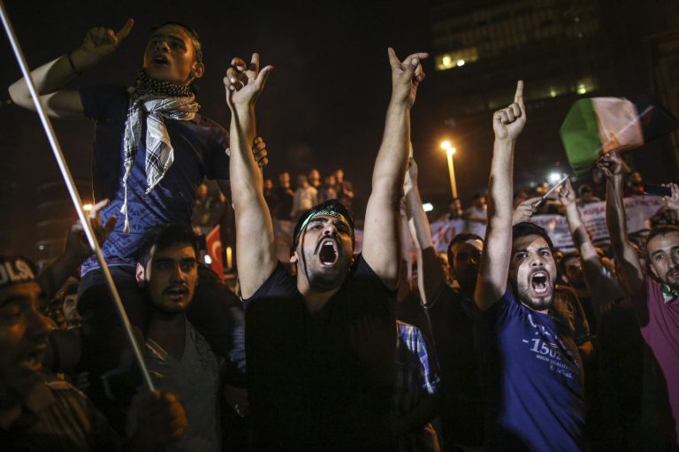 Pro-Palestinian Turks shout slogans against Israel during a protest rally outside the Israeli consulate in Istanbul, Turkey, early Friday, July 18, 2014. Israel launched an offensive late Thursday after becoming increasingly exasperated with unrelenting rocket fire from Gaza on its cities, especially following Hamas' rejection of an Egyptian cease-fire plan earlier in the week. (AP Photo/Emrah Gurel)