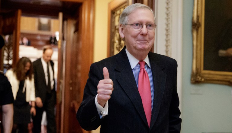 Senate Majority Leader Mitch McConnell of Ky. signals a thumbs-up as he leaves the Senate chamber. (AP Photo/J. Scott Applewhite)
