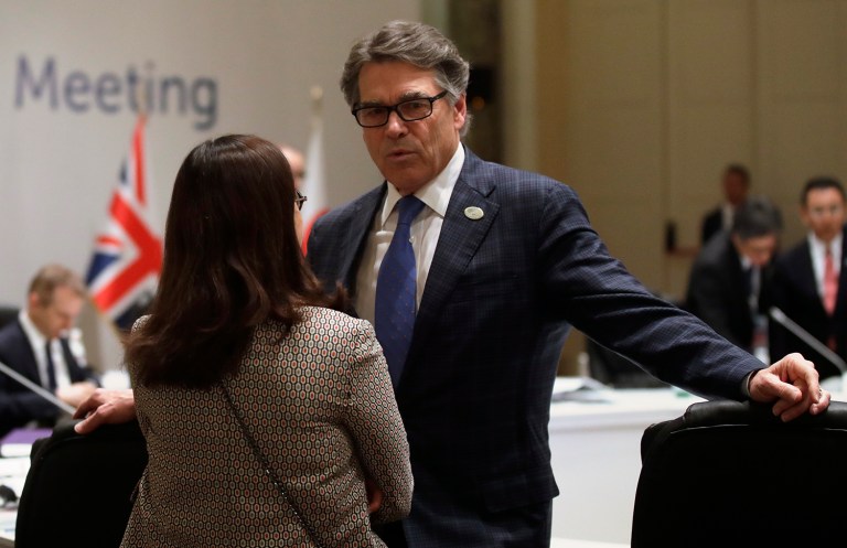 Energy Secretary Rick Perry speaks to a woman ahead of a G7 Energy meeting in Rome on Monday, April 10, 2017. (AP Photo/Alessandra Tarantino)