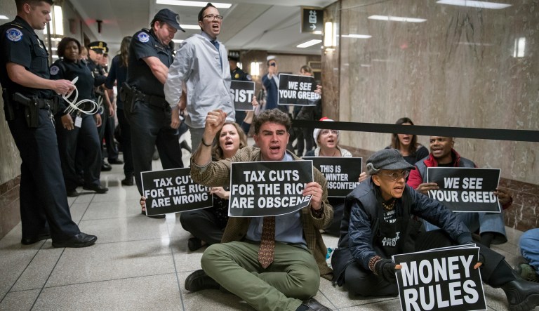 Protesters, including several people in wheelchairs, entered the committee hearing room and chanted 