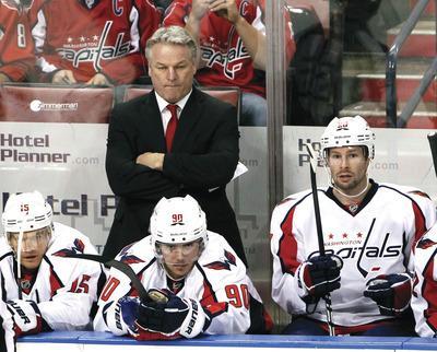 Washington Capitals head coach Dale Hunter, rear, looks on during the first period of an NHL hockey game against the Florida Panthers, Monday, Dec. 5, 2011, in Sunrise, Fla. The Panthers defeated the Capitals 5-4.(AP Photo/Wilfredo Lee)