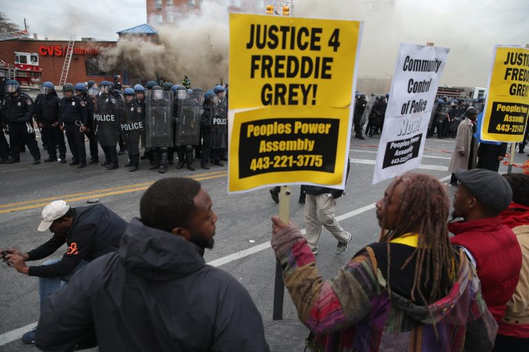 Demonstrators face off with Baltimore Police as a CVS pharmacy burns at the corner of Pennsylvania and North avenues during violent protests following the funeral of Freddie Gray April 27, 2015 in Baltimore, Md. (Photo by Chip Somodevilla/Getty Images)