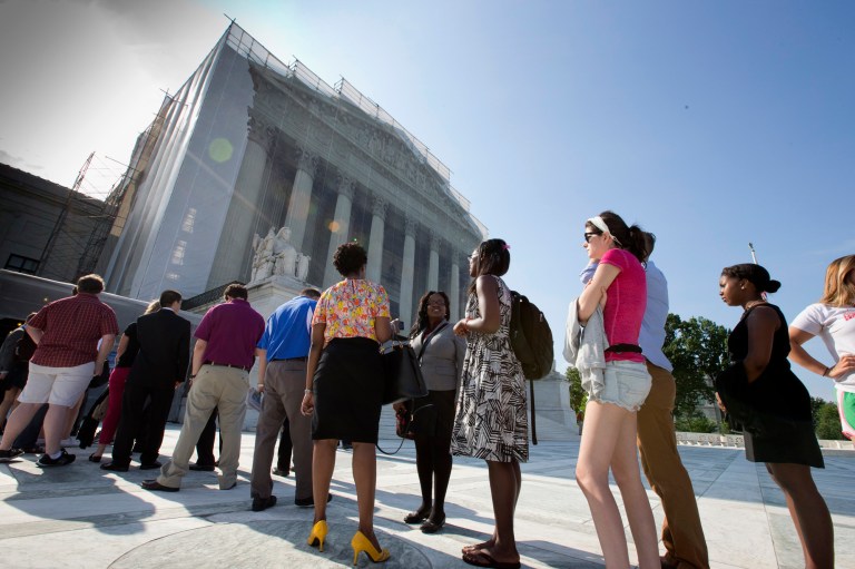 J. Scott Applewhite/AP
Visitors wait outside the Supreme Court in Washington on Thursday.