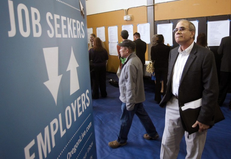 In this April 24, 2012, file photo, job seeker Alan Shull attends a job fair in Portland, Ore. (AP Photo/Rick Bowmer, File)