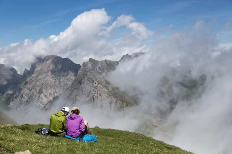 In this picture taken Saturday June 21, 2104, hikers take a rest  on the Alvier mountain  in the Swiss Alps near Truebbach , Switzerland. (AP Photo/Keystone,Arno Balzarini)