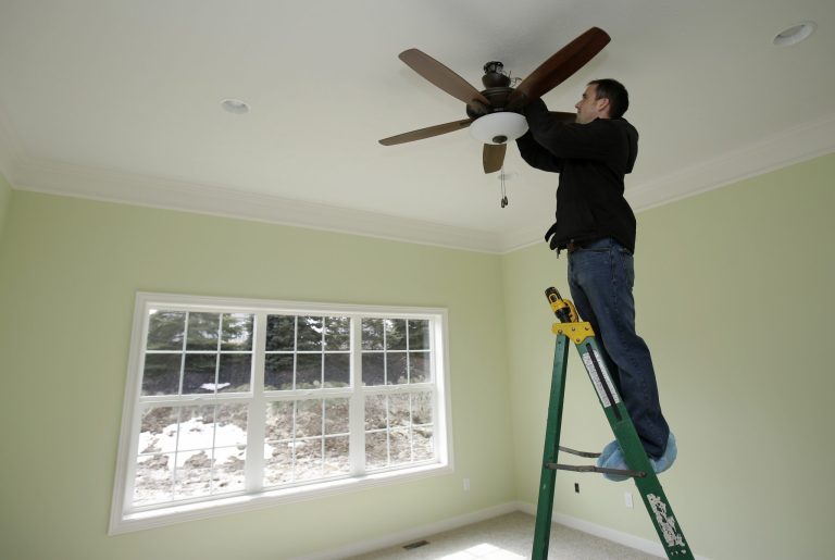 In this Friday, March 21, 2014 photo, Pete Christman installs a remote control for a fan in a new home in Pepper Pike, Ohio. The National Association of Home Builders reports on sentiment among U.S. builders on Thursday, May 15, 2014. (AP Photo/Tony Dejak)