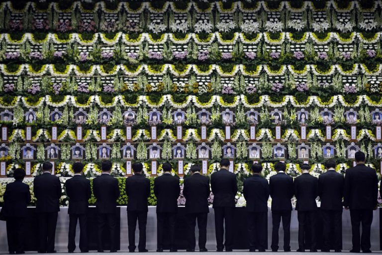 Mourners pay tribute to the victims of the sunken ferry Sewol during a temporary memorial at the auditorium of the Olympic Memorial Museum in Ansan, south of Seoul, South Korea, Thursday, April 24, 2014. Divers made their way deeper Thursday into the submerged wreck of the ferry that sank more than a week ago as the death toll neared 160 and relatives of the more than 140 still missing pressed the government to finish the grim task of recovery soon. (AP Photo/Lee Jin-man)