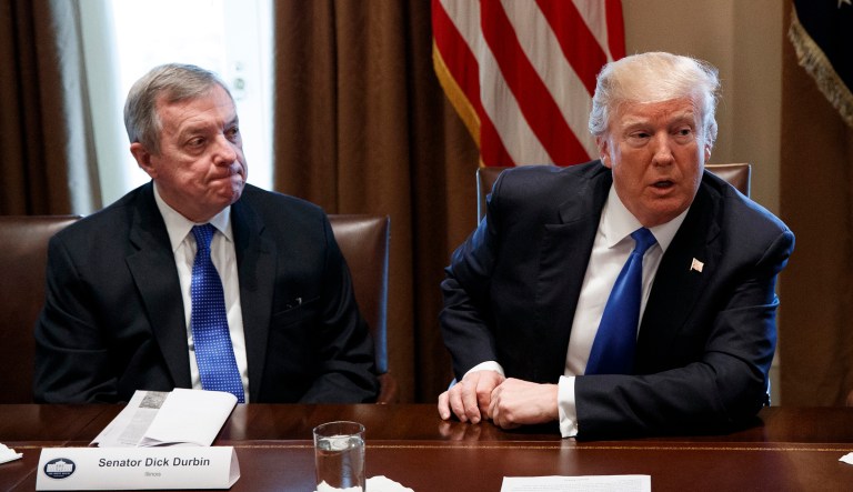Sen. Dick Durbin, D-Ill., listen as President Trump speaks during a meeting with lawmakers on immigration policy. 