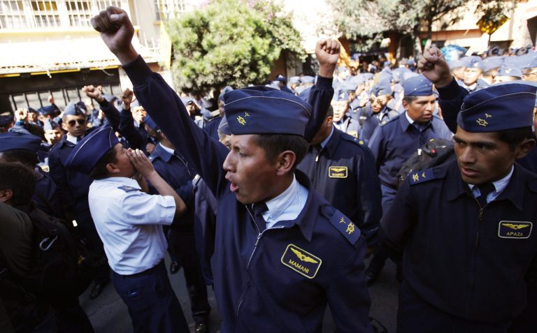 Members of the Air Force shout slogans as they protest in La Paz, Bolivia, Tuesday, April 22, 2014. Hundreds of low ranking soldiers from Bolivia's Armed Forces marched against the military high command's dismissal of four of its leaders who defended their call for more career opportunities. Soldiers who study three years to be sergeants and then warrant officers want the opportunity to rise in rank, according to Felix Jhonny Gil, president of the National Association of Warrant Officers and Sergeants. The soldiers' wives started a hunger strike in solidarity. (AP Photo/Juan Karita)