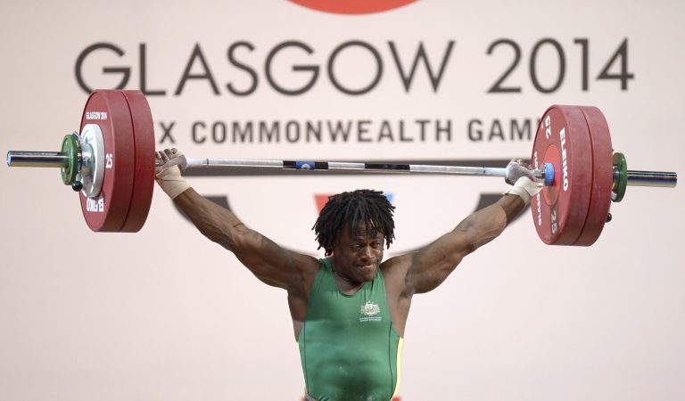 In this photo taken Friday July 27 2014, Francois Etoundi of Australia lifts during the men's 77kg weightlifting competition in the Commonwealth Games Glasgow 2014 in Glasgow Scotland.   Etoundi,  was stripped of his games accreditation Thursday July 31, 2014  after being arrested over an alleged assault during an altercation in the athletes' village in Glasgow.   (AP Photo/Dominic Lipinski, PA) UNITED KINGDOM OUT NO SALES NO ARCHIVE