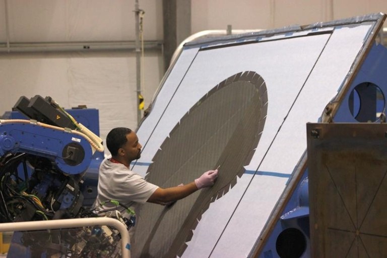 Mark Moody, an employee of Lockheed Martin Corp., works on preparations for a brace for the Dream Chaser mini-space shuttle designed by Sierra Nevada Corp. - one of three companies working on spacecraft to get NASA astronauts to and from the International Space Shuttle. Lockheed Martin also has two other, unrelated, projects at Michoud Assembly Facility in eastern New Orleans - a campus where thousands of people worked in the 1980s to build space shuttle fuel tanks. (AP Photo/Janet McConnaughey)