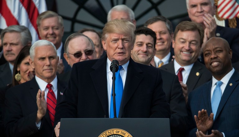 In this Dec. 20, 2017 photo, President Trump, joined by Vice President Mike Pence, Speaker of the House Paul Ryan, R-Wis., and other members of Congress, pauses as he speaks during an event on the South Lawn of the White House in Washington, to acknowledge the final passage of tax overhaul legislation by Congress. (AP Photo/Carolyn Kaster)