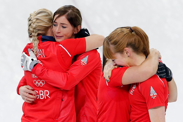 Britain's women's curling team from left to right, Anna Sloan, Eve Muirhead, Vicki Adams and Claire Hamilton, celebrate after beating Switzerland in the women's curling bronze medal game at the 2014 Winter Olympics, Thursday, Feb. 20, 2014, in Sochi, Russia. (AP Photo/Wong Maye-E)