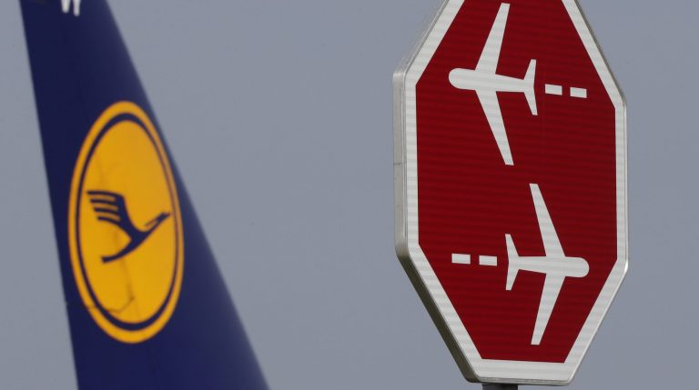 A Lufthansa aircraft passes a signpost at the airport in Munich during an eight-hour warning strike of Lufthansa pilots in Munich, southern Germany, Wednesday, Sept. 10, 2014. (AP Photo/Matthias Schrader)