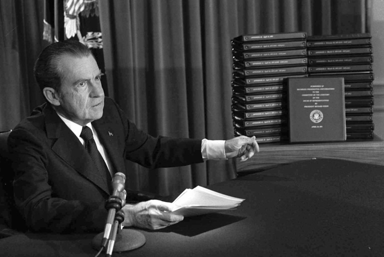 President Richard Nixon points to the transcripts of the White House tapes after he announced during a nationally-televised speech that he would turn over the transcripts to House impeachment investigators. (AP)