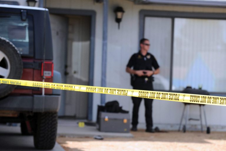 Police stand outside a home in Prescott Valley, Ariz., Friday, June 7, 2013, where an Arizona man was accidentally shot by his 4-year-old son. Justin Stanfield Thomas was fatally shot Friday after he and his son traveled from Phoenix to a friend's home 90 miles away in the northern Arizona community of Prescott Valley for a surprise visit. Prescott Valley Police Brandon Bonney says the boy found the loaded gun in the home within minutes of arrival, asked a question about it and pulled the trigger. (AP Photo/Prescott Daily Courier, Les Stukenberg)