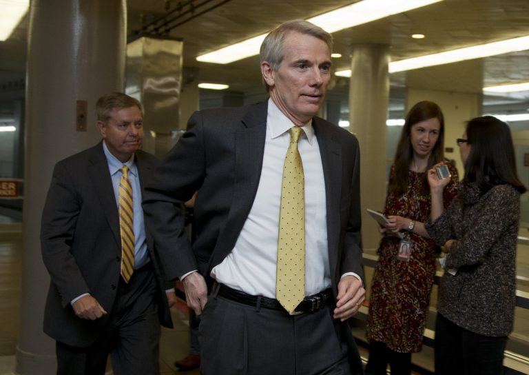 Sen. Rob Portman, R-Ohio, center, followed by Sen. Lindsey Graham, R-S.C., back left, walk from the Senate subway on Capitol in Washington, Friday, Dec. 12, 2014. (AP Photo/Manuel Balce Ceneta)