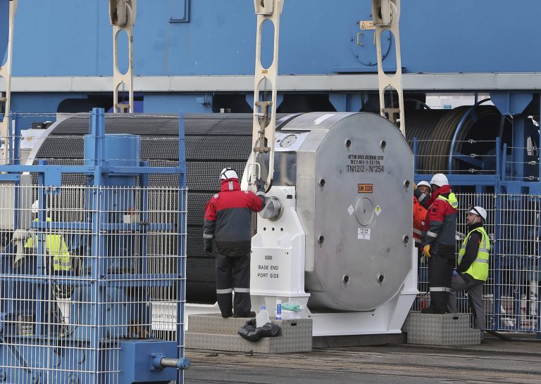 Harbour and Areva workers check a container carrying uranium oxide to make fuel pellets called MOX, before being lifted onto the Pacific Egret cargo in western France in April 2013. (AP Photo/David Vincent)