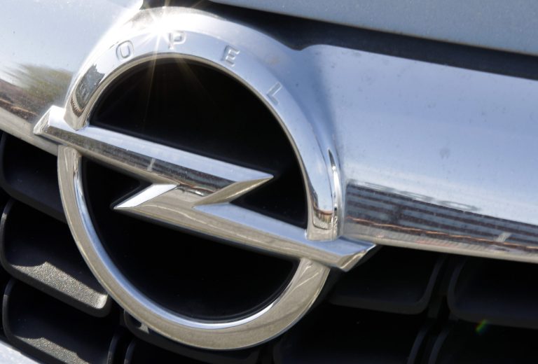   FILE - In this March 26, 2012 file picture a car shows the Opel logo while reflecting the front of the Opel car manufacturer plant in Bochum on, in Bochum, Germany. General Motors says its Opel subsidiary is in 