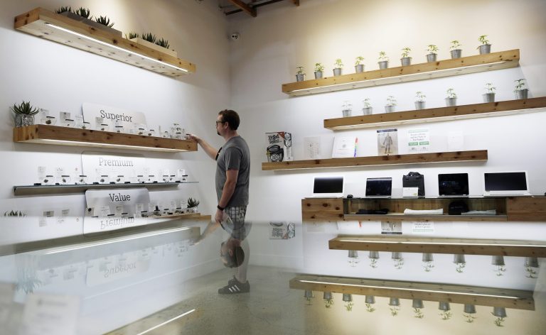 A man shops for marijuana at The Source dispensary in Las Vegas. If a state decriminalizes, they still would like to have funds to dedicate to more roadway safety as well as to education and prevention programs aimed at youth. However, without the revenue that comes from retail sales, these states arenât sure how to pay for those programs. (AP Photo/John Locher)