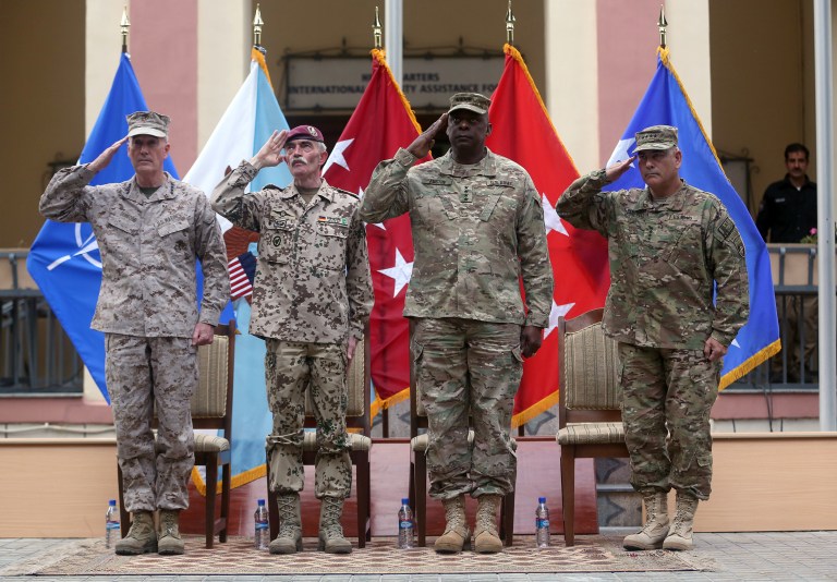 Outgoing commander of ISAF, U.S. Gen. Joseph Dunford, first left, and incoming U.S. Army Commander for International Security Assistance Forces (ISAF), Gen. John F. Campbell, first right, salute during a change of command ceremony at the ISAF Headquarters in Kabul, Afghanistan, Tuesday, Aug. 26, 2014. ISAF is a NATO-led security mission in Afghanistan that was established by the United Nations Security Council in 2001. It will end its mission at the end of 2014. (AP Photo/Massoud Hossaini)