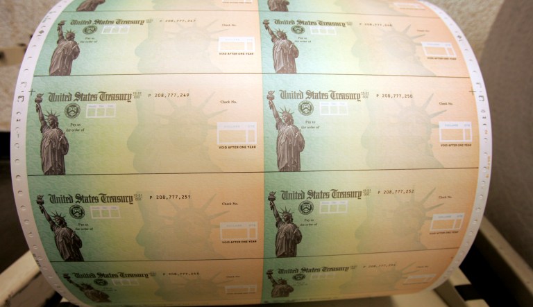 Acting as if we have a gold-plated government credit card, we Americans buy more government services than we pay for. (AP Photo/Matt Rourke)