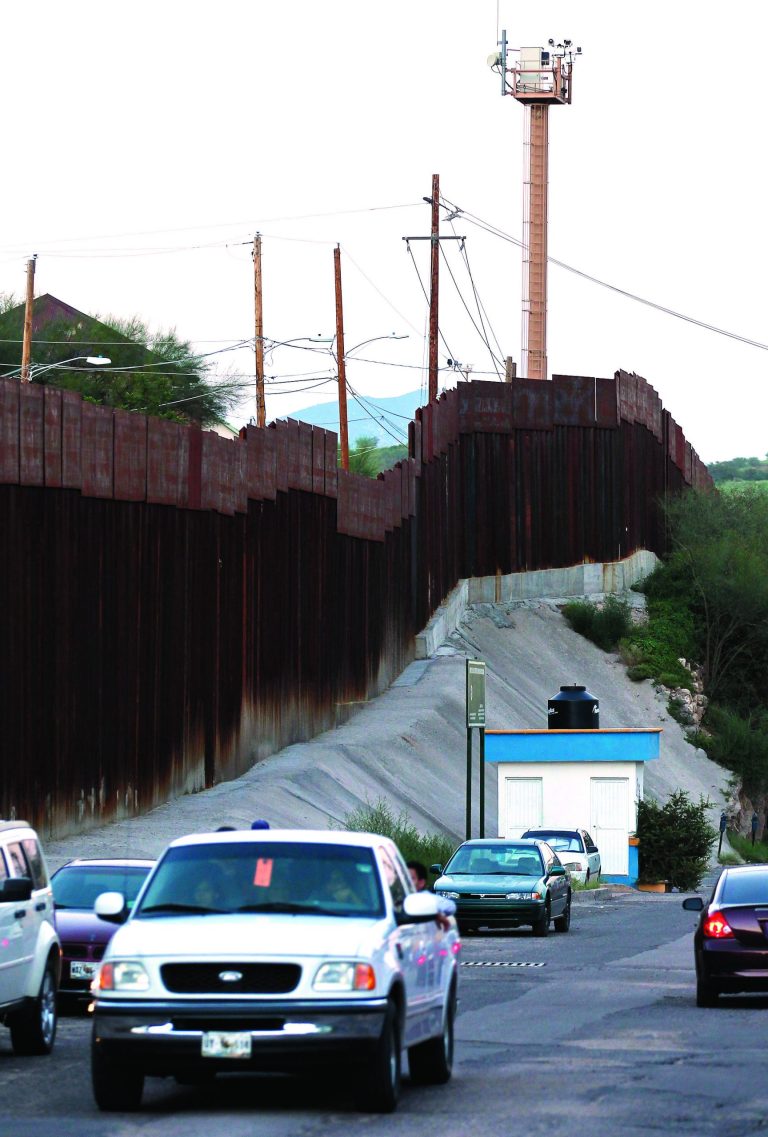 In this photo taken Thursday, Aug. 9, 2012, vehicles drive along the border fence in Nogales, Mexico. A U.S. Border Patrol agent opened fire on a group of people throwing rocks from across the Mexican border, killing a teenage boy and eliciting outrage from the Mexican government over the use of lethal force, authorities said Thursday, Oct. 11, 2012. (AP Photo/Ross D. Franklin)