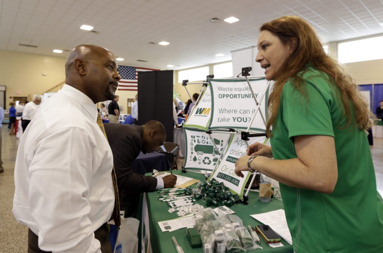 In this photo taken Wednesday, July 16, 2014, job seeker U.S. Air Force veteran Jimmie Walker, left, listens to job recruiter Desiree Akel, at a Hiring Fair For Veterans in Fort Lauderdale, Fla. The Labor Department reports the number of people who applied for unemployment benefits last week on Thursday, July 17, 2014. (AP Photo/Alan Diaz)
