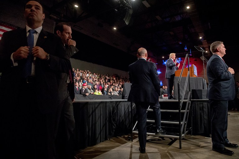 Secret Service agents stand guard as President-elect Trump speaks at a rally. A top Trump transition aide blasted Politico for publishing a story about the president-elect maintaining a private security detail in addition to Secret Service protection. (AP Photo/Andrew Harnik)