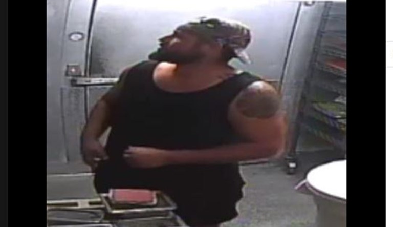 A man cooks a burger patty while robbing a Wendy's fast food restaurant in Martin County, Florida.