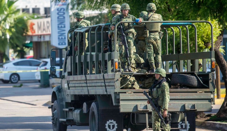 Mexican soldiers patrol around the city after a gunfight  between gunmen and army officers in Culiacan, Mexico, on Friday Oct. 18, 2019. Mexican officials say eight people were killed in gunbattles in the Sinaloa state capital of Culiacan in what is being described as a failed operation to detain the son of convicted Sinaloa cartel boss JoaquÃ­n âEl Chapoâ GuzmÃ¡n. 