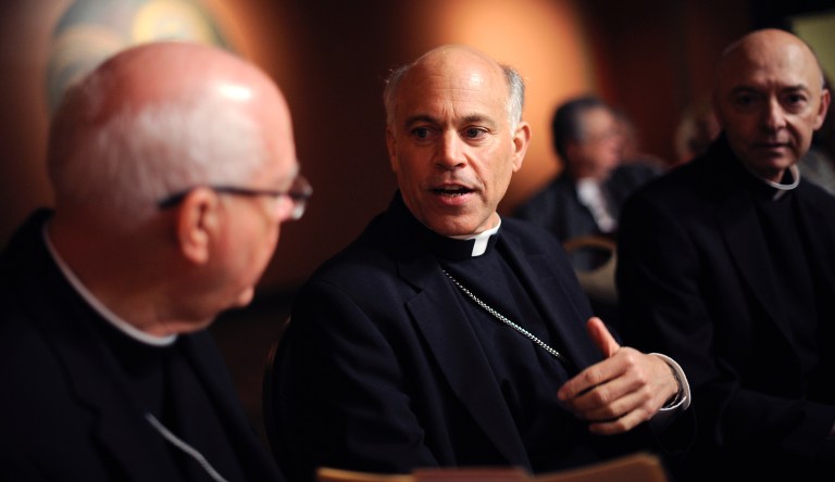 File - In this July 27, 2012 file photo, newly appointed San Francisco Archbishop Salvatore Cordileone, center, speaks with other members of the church during a press conference held at St. Mary's Cathedral in San Francisco. Roman Catholics in this city named for humble St. Francis are in turmoil, sparring with each other over social media and letters to the editor over one controversial figure, the Archbishop Salvatore Cordileone. 