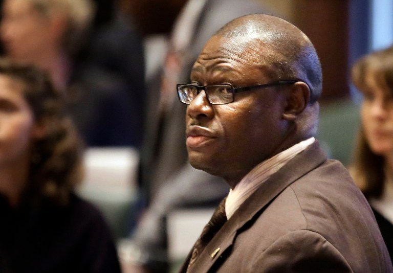 FILE - In this May 21, 2014 file photo, Illinois Rep. Derrick Smith, D-Chicago, listens to lawmakers at the state Capitol in Springfield. Smith is scheduled to go on trial on bribery charges Wednesday, May 28, 2014, with jury selection beginning at federal court in Chicago. He was charged in 2012 with taking a $7,000 bribe from a day care operator seeking a state grant. (AP Photo/Seth Perlman, File)