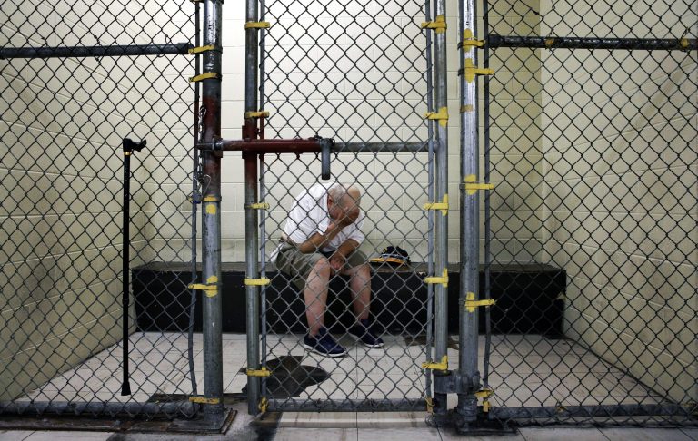 A U.S. veteran with post-traumatic stress sits in a segregated holding pen at the Cook County Jail after he was arrested on a narcotics charge in Chicago. (AP Photo/Charles Rex Arbogast)
