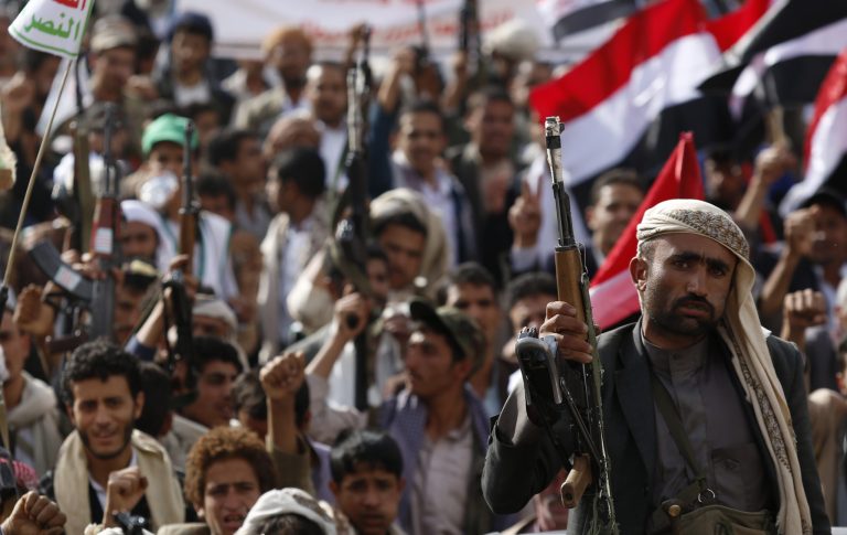A Shiite rebel known as Houthi, holds up his weapon during a rally against Saudi-led airstrikes in Sanaa, Yemen, Sunday, June 14, 2015. (AP Photo/Hani Mohammed)