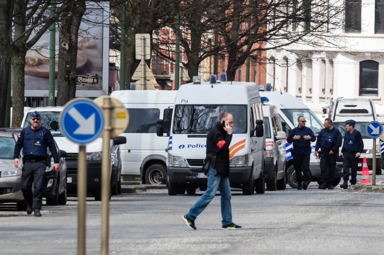 Police secure an area during a house search in the Etterbeek neighborhood in Brussels on Saturday April 9, 2016. The arrest Friday of six men suspected of links to the Brussels bombings, including the last known fugitive in last year's Paris attacks, raised new questions about the extent of the Islamic State cell believed to have carried out the intertwined attacks that left 162 people dead in two countries. (AP Photo/Geert Vanden Wijngaert)