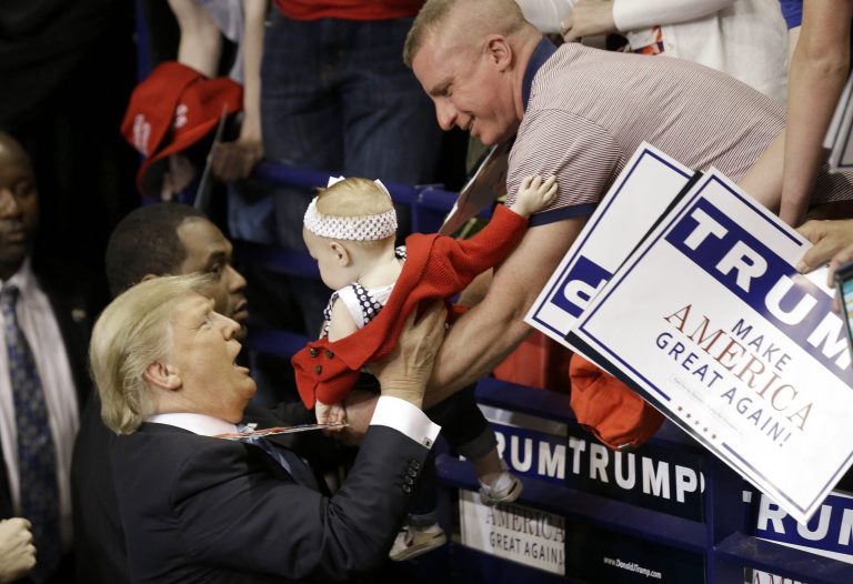 Republican presidential candidate Donald Trump reaches for a baby during a campaign rally in Fayetteville, N.C., Wednesday, March 9, 2016.