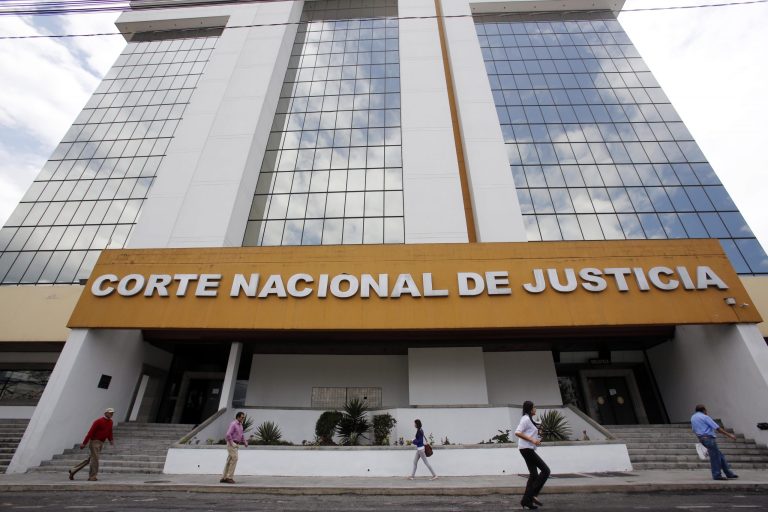 People walk past the Supreme Court in Quito, Ecuador, Wednesday, Jan. 29, 2014. A leading international human rights group accused Ecuador's government Wednesday of severely undermining the independence of the country's judiciary through the removal and naming of hundreds of judges following a 2011 referendum that endorsed reform. (AP Photo/Dolores Ochoa)