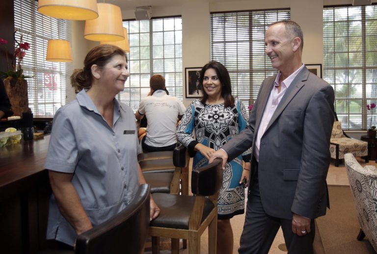 Yolanda Oruc, left, talks to general manager Jeff Lehman, right, and HR director Nilmarie Almdovar, center, in the lobby of the Betsy Hotel in the South Beach area of Miami Beach, Fla. (AP/Alan Diaz)

