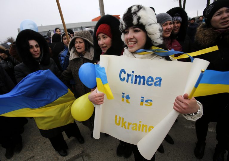 Crimean Tatars shout slogans during the pro-Ukraine rally in Simferopol, Crimea, Ukraine, Monday, March 10, 2014. Russian President Vladimir Putin on Sunday defended the separatist drive in the disputed Crimean Peninsula as in keeping with international law, but Ukraine's prime minister vowed not to relinquish 