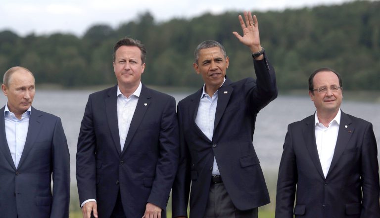 President Obama, second from the right, waves as he stands with, from left, Russian President Vladimir Putin, British Prime Minister David Cameron and French President Francois Hollande, during a group photo opportunity as part of the G-8 summit in Enniskillen, Northern Ireland, on June 18. (AP Photo/Lefteris Pitarakis)