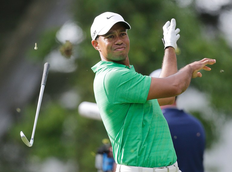   Tiger Woods lets go of his club after hitting a shot on the 14th hole during the third round of the U.S. Open Championship golf tournament Saturday, June 16, 2012, at The Olympic Club in San Francisco. (AP Photo/Eric Gay)  