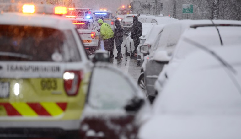 Tow truck drivers talk with an Illinois State Trooper after a 54 car pile-up early morning on the Kennedy Expressway Wednesday, April 15, 2020, in Chicago.