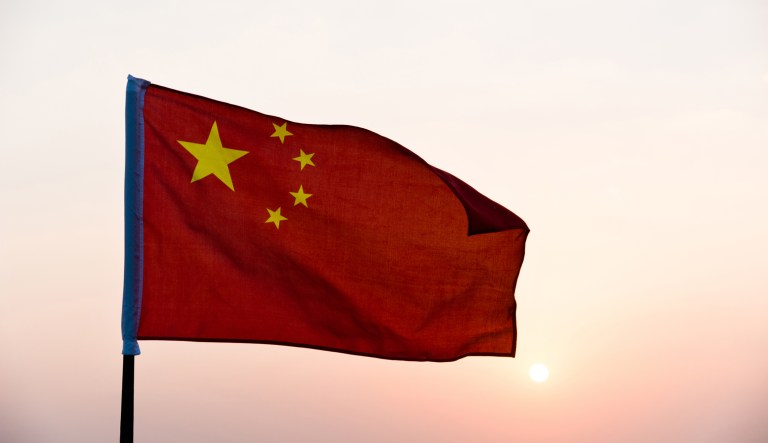 China flag waving in sunset.